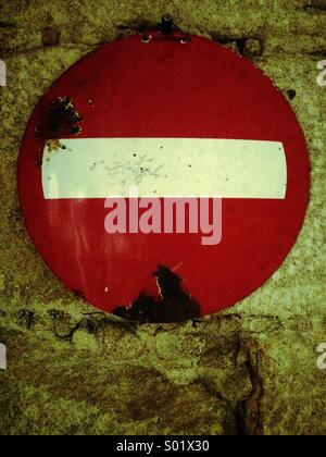 Old Stop sign, Rusty, stone wall Stock Photo