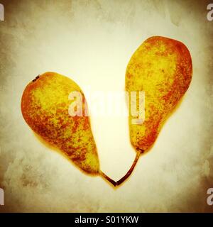Two pears against light textured background Stock Photo