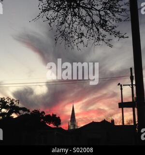 Pink dusk clouds silhouette cathedral in Lakeview New Orleans. Stock Photo