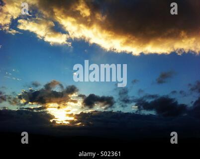 Sunlit clouds at sunset Stock Photo