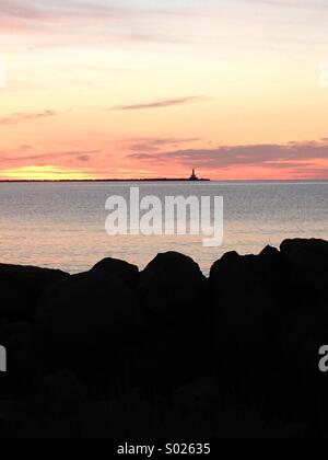 Lighthouse silhouetted at sunrise on Lake Superior, Michigan Stock Photo