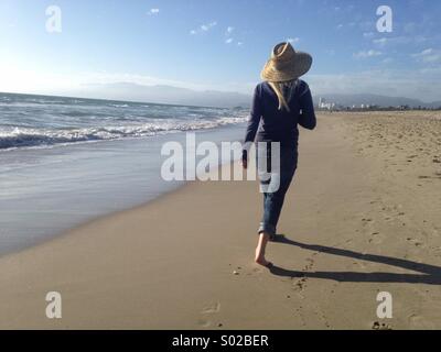 Blonde woman walking on beach in Los Angeles Stock Photo