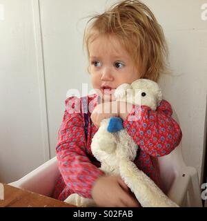 Toddler holding her teddybear Stock Photo