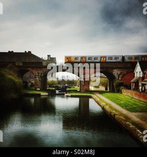 A train crosses the last section of the Liverpool side of the Liverpool to Leeds canal Stock Photo