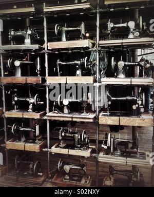 Rows of antique sewing machines in shop window Stock Photo