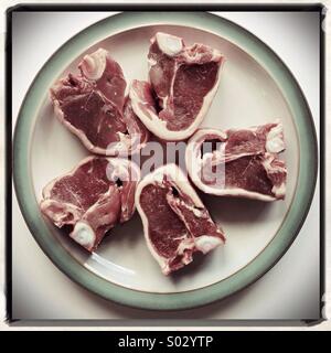 Five lamb chops on a plate Stock Photo