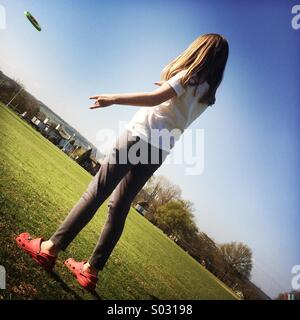 Girl Throwing A Frisbee Stock Photo