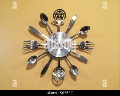 Clock made out of silverware and various kitchen utensils Stock Photo