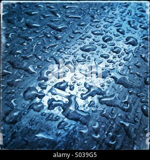 Blue water drops on a table Stock Photo