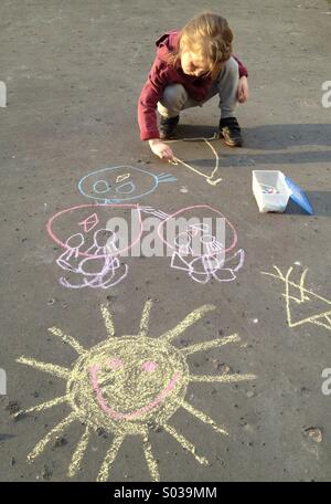 Little girl drawing with chalk Stock Photo