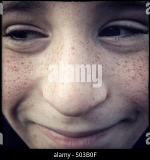 Close up face of young cheeky boy smiling Stock Photo
