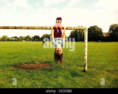 Girl hanging upside down Stock Photo