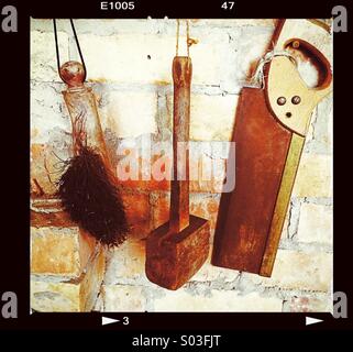 Tools and brush hanging up Stock Photo