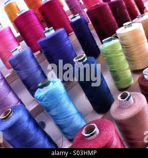 Cotton reels on a rack Stock Photo
