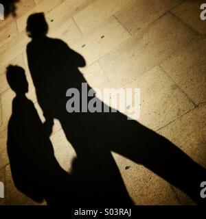 Shadow of mother and child walking on the street in Barcelona