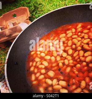 Baked beans being cooked outdoors. Stock Photo