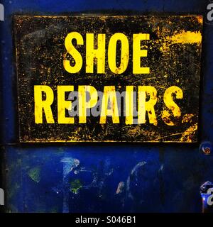 Shoe Repairs sign at an old-fashioned cobblers shop. Stock Photo