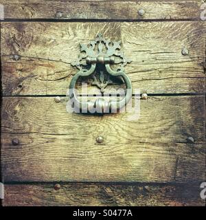Metal door knocker on old wooden door Stock Photo