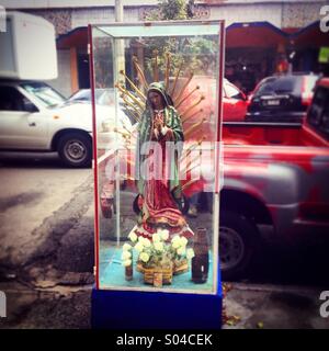 An altar with an sculpture of the Virgin of Guadalupe is displayed outside of Medellin Market, Colonia Roma, Mexico City, Mexico Stock Photo