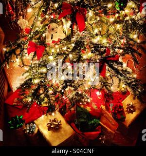 Christmas tree with gifts underneath. Stock Photo