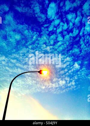 Lamppost in front of cloudy sky Stock Photo