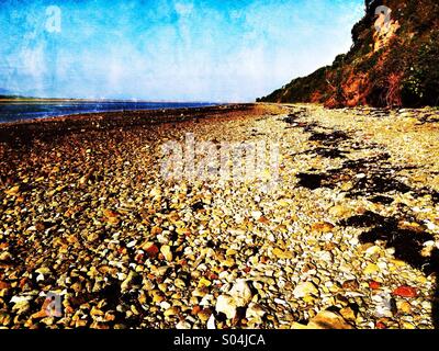 Shingle beach by Menai Strait on Anglesey Stock Photo