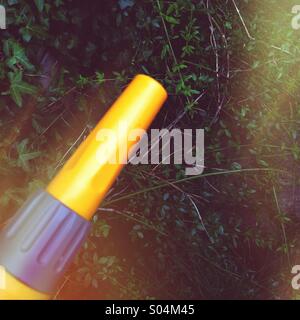 Hose nozzle in garden on a sunny day. Stock Photo