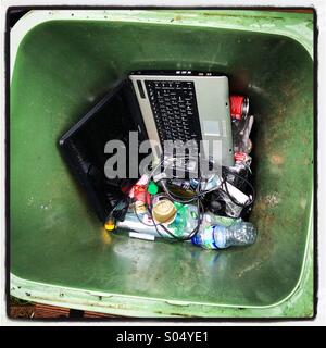 Obsolete laptop in the rubbish bin. Instagram style iPhone mobile phone photo. Stock Photo