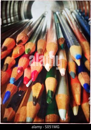 Collection of colored pencils in tin can on its side Stock Photo