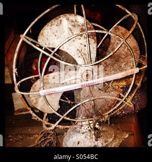 Abandoned vintage metal table fan. Found in a basement that has not been in use since the 1940's. Photo taken in Pittsburgh,Pa US. Stock Photo