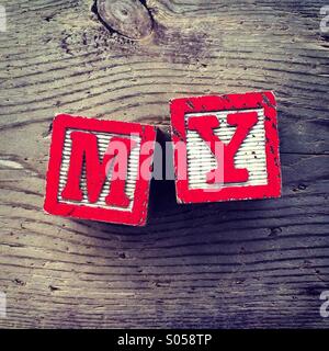 It's a photo of two wood cubes toy with letters that form the word MY Stock Photo