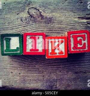 It's a photo of few wood blocks with alphabet letters combined together to create the word LIKE Stock Photo