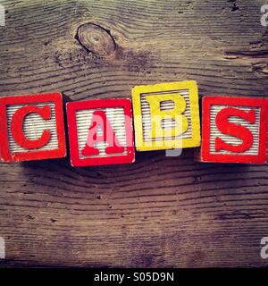 It's a photo of few wood blocks toys with alphabet letters on them combined together to create the word CABS Stock Photo