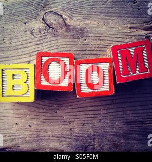 It's a photo of few wood blocks with letter on them that are combined together to create the word BOOM Stock Photo