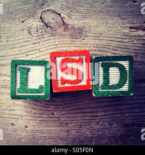 It's a photo of few wood blocks with letter on them that are combined together to create the acronym word LSD Stock Photo