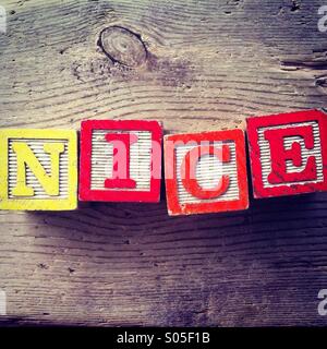 It's a photo of few wood blocks with letter on them that are combined together to create the word NICE Stock Photo