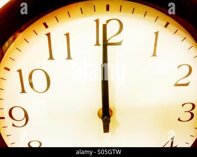 Hands of a clock at twelve o'clock. Stock Photo