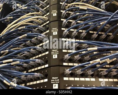 Ethernet cables plugged into server racks. Stock Photo