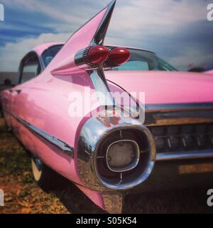 Rear view of pink Cadillac Classic car, UK