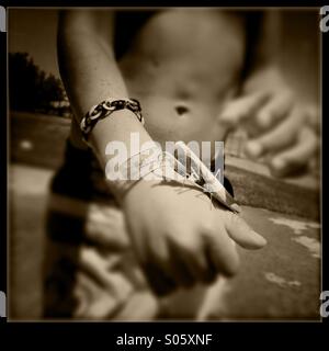 Praying mantis on a six year old boy's hand. Stanislaus county, California, USA Stock Photo