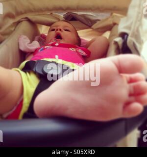 Baby girl lying in stroller Stock Photo