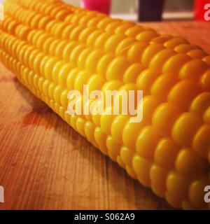 Boiled corn close up on wooden board Stock Photo