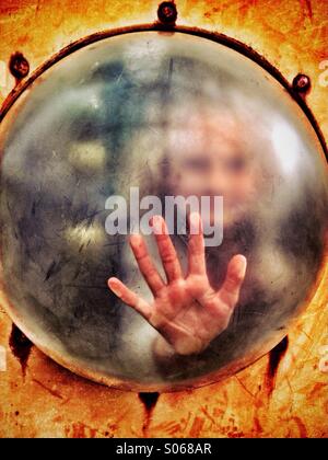 Child's hand on plastic dome Stock Photo