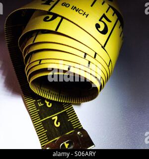 A measuring tape used to determine measurements. Stock Photo