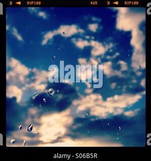 Water droplets on window and clouds Stock Photo