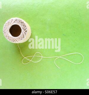 Ball of string on green Stock Photo