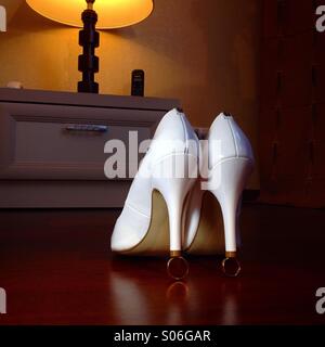 Bride shoes on weddin rings Stock Photo