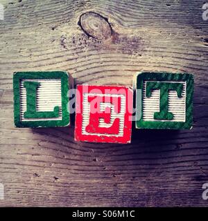 It's a photo of woodblocks toys will alphabet letter on them which are combines together to create the word LET Stock Photo