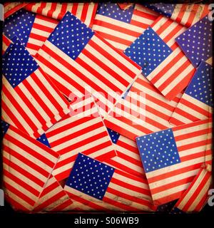 Miniature paper Stars and Stripes,the flag of the United States form a vintage background Stock Photo