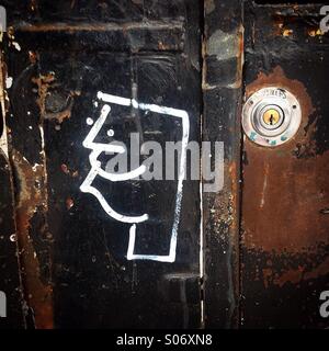 A drawing of a man head's profile decorates an old door in Colonia Roma, Mexico City, Mexico Stock Photo